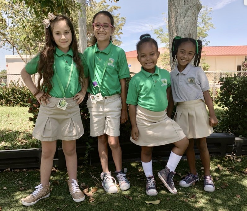Four Greentree students under a tree